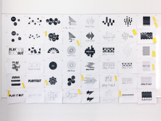 Play It Out logo concepts on the wall